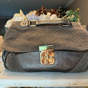 Faux leather handbag with rhinestone accents . Material multi pocketed lining